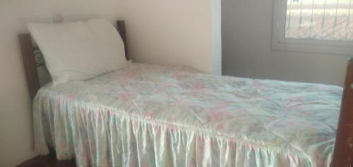 a bedroom with a bed with a pillow and a window at VIVEZ BIEN in Meknès