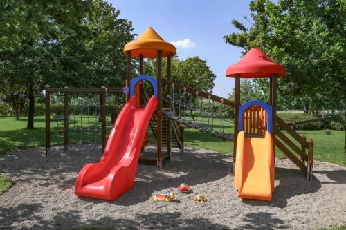 a playground with three slides in a park at Agriturismo Il Brugnolo in Scandiano