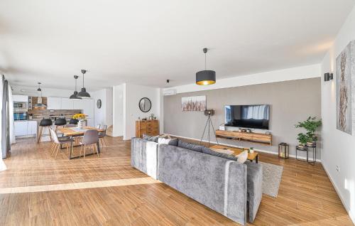 a living room with a couch and a dining room at Beautiful Home In Sevid Na Moru in Sevid