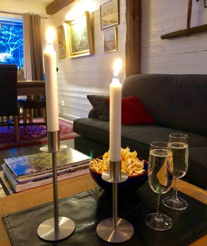 a table with two candles and a plate of food and wine glasses at Slamrekullen - Ullared in Ullared
