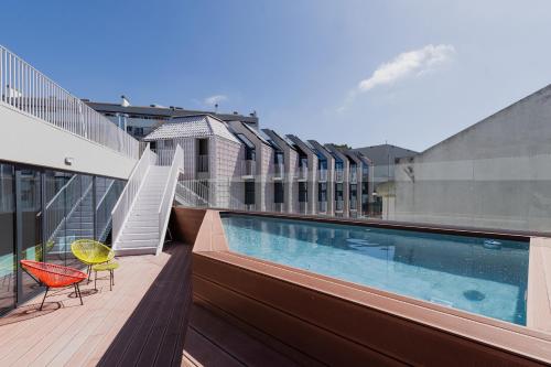 a balcony with a swimming pool on top of a building at StudentVille Central in Lisbon