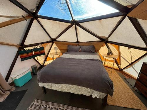 a bedroom in a yurt with a bed in it at Raptor Ranch in Valle
