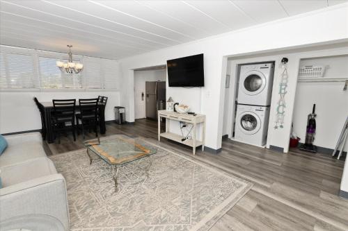 a living room with a couch and a washer and dryer at Sea Palm 1D condo in Fort Walton Beach
