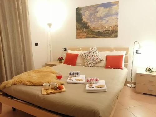 a bedroom with a bed with a tray of food on it at Appartamento con terrazza e giardino in Val d'Intelvi in Lanzo dʼIntelvi