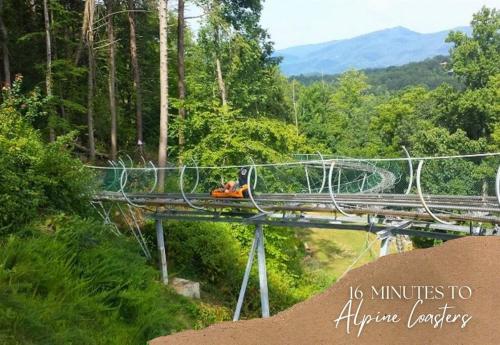 a group of people on a zip line over a bridge at Willow Trace: Family Retreat, Hot Tub, Gaming! in Pigeon Forge