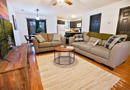 a living room with a couch and a table at Willow Trace: Family Retreat, Hot Tub, Gaming! in Pigeon Forge