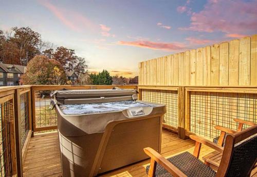 a grill on a deck with a table and chairs at Willow Trace: Family Retreat, Hot Tub, Gaming! in Pigeon Forge