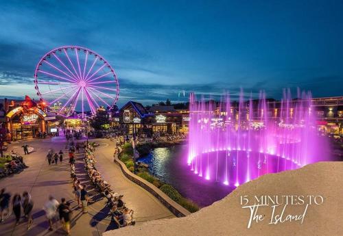 a amusement park with a ferris wheel and a water fountain at Willow Trace: Family Retreat, Hot Tub, Gaming! in Pigeon Forge