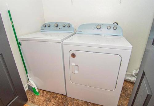 a small white washer and dryer in a room at Willow Trace: Family Retreat, Hot Tub, Gaming! in Pigeon Forge