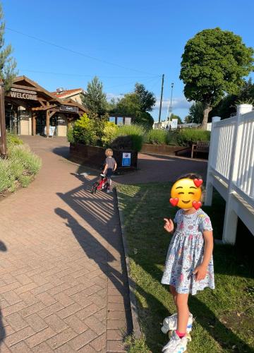a little girl standing next to a child on a bike at Seton Sands Caravan Near Edinburgh & North Berwick in Port Seton