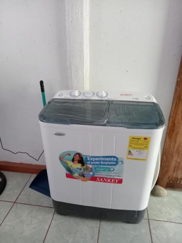 a washing machine with a cover on top of it at Dulce Horizonte in Puerto Jiménez