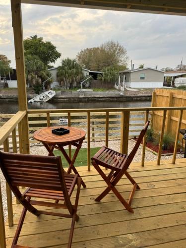 a wooden deck with a table and two chairs at The memories house in Tampa