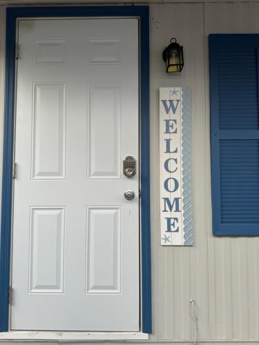 a white door with a welcome sign on a house at The memories house in Tampa