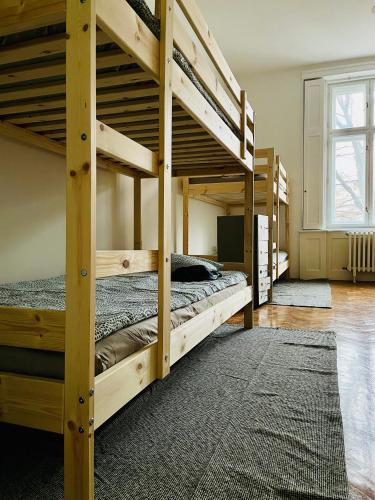 a bedroom with three bunk beds in a room at Hostel Green World in Novi Sad