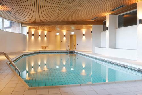 a pool in a building with a swimming pool at NSV-Apartments am Waldrand in Bad Essen