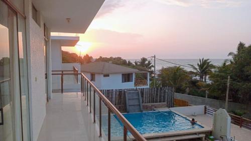 a balcony of a house with a swimming pool at LA COLINA Casa-Hospedaje in Máncora