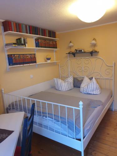 a white crib in a room with bookshelves at Traumpfade in Boppard