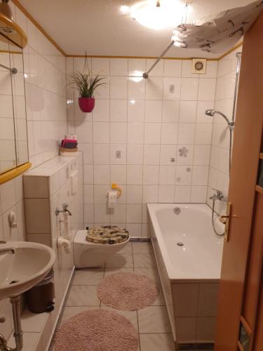 a bathroom with a tub and a toilet and a sink at Traumpfade in Boppard