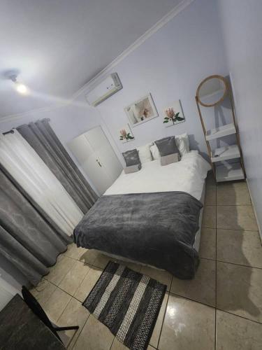 a bedroom with a bed and a book shelf at Elina Self catering in Ongwediva