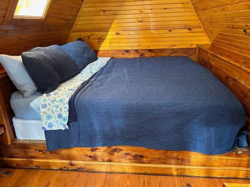 a bedroom with a bed in a wooden cabin at A-Frame Cabin #5 with Hot Tub on Patoka Lake in Southern Indiana in Paoli