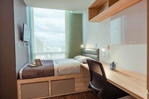 Un ou plusieurs lits dans un hébergement de l'établissement UMA Suites Chia