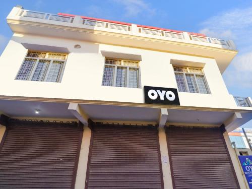 a white building with a yes sign on it at OYO Hotel Mount View in Haldwāni