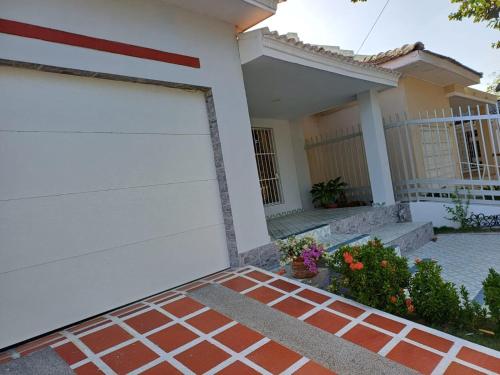 a white garage door in front of a house at Casa Bellavista Barranquilla in Barranquilla