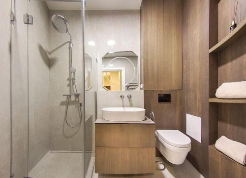 a bathroom with a shower and a sink and a toilet at Butas Šiaulių mieste in Šiauliai