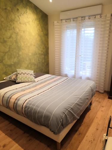 a bedroom with a large bed with a window at Chambre dans un écrin de verdure in Dommartin