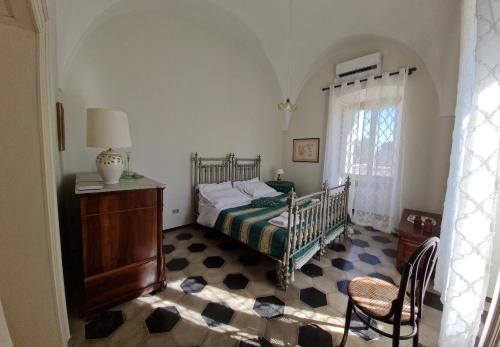 a bedroom with a bed and a dresser and a window at Villa Morea-Relax in piscina in Putignano