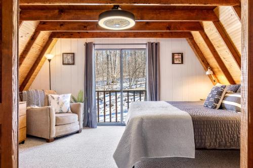 a bedroom with a bed and a chair and a window at 614 Aspen Woods Chalet in Innsbrook