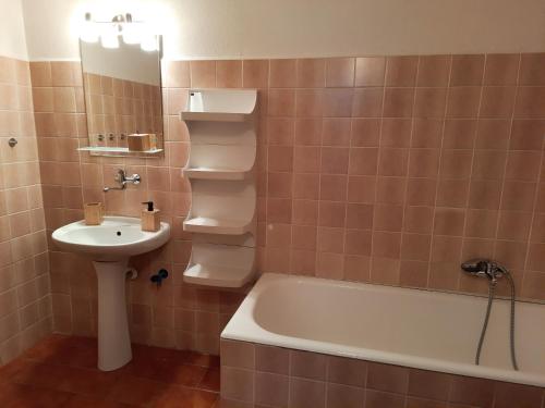 a bathroom with a sink and a toilet and a tub at Pension Aneta in Vysoké nad Jizerou