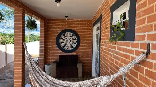 a porch with a hammock on a brick house at Artista Helo Ceres0025 in Cuiabá