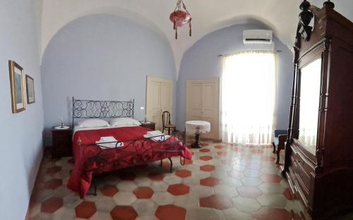 a bedroom with a bed and a large window at Villa Morea-Relax in piscina in Putignano
