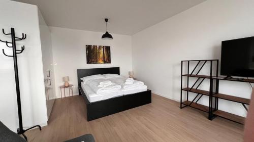 a bedroom with a bed and a flat screen tv at 2 room Apartment with terrace, new building, 35 in Bratislava