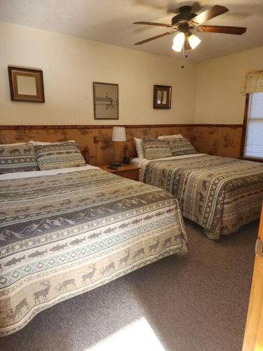 a bedroom with two beds and a ceiling fan at Optimum #9 with Hot Tub and Jacuzzi on Patoka Lake in Southern Indiana in Tunnelton