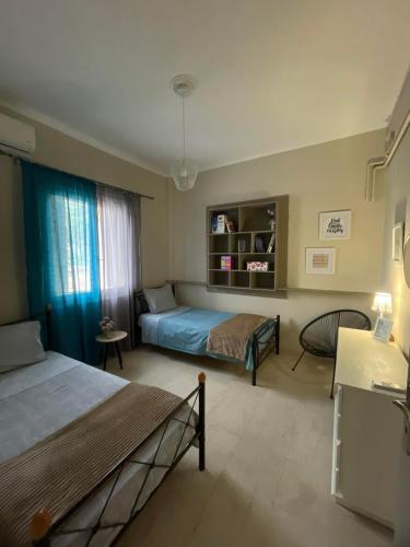 a hotel room with two beds and a window at Εξοχικό elia lakonias in Elia Laconias