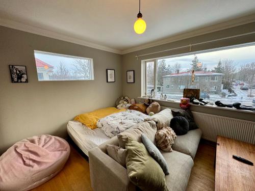 uma sala de estar com um sofá e uma grande janela em Cozy, central Apartment em Reykjavík