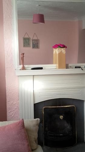 a fireplace with a gift bag on top of it at Twenty-six in Kings Lynn
