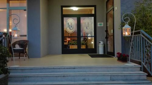 a front door of a house with stairs and lights at Hotel Umberto in Rosolina Mare