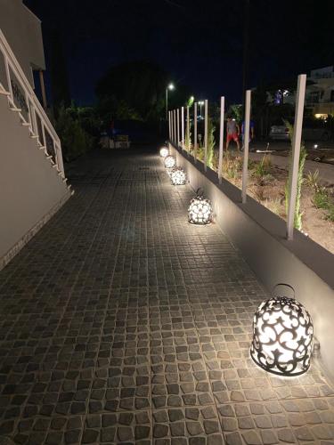 a row of lights on a sidewalk at night at RHODIAN TREASURE Spiridione apartment in Rhodes Town
