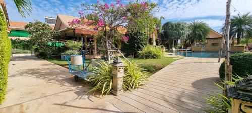 a house with a fire hydrant on a wooden walkway at Chang Noi Hua Hin Pranburi fully accessible barrierefrei resort in Ban Nong Sua