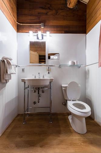 a bathroom with a white toilet and a sink at Colter Bay Village in Colter Bay Village