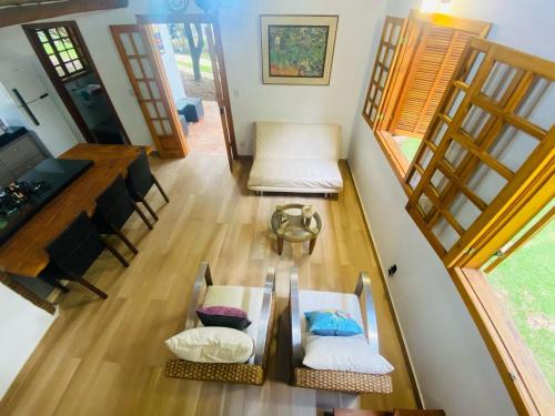 an overhead view of a living room with a table and chairs at Casa de Campo Pampulha in Belo Horizonte
