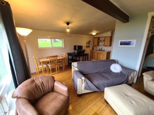 a living room with a couch and a table at Eagles Perch Retreat in Hansville
