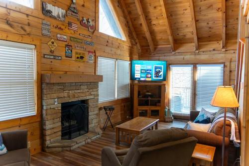 a living room with a fireplace and a tv at Heavenly Peace in Pigeon Forge