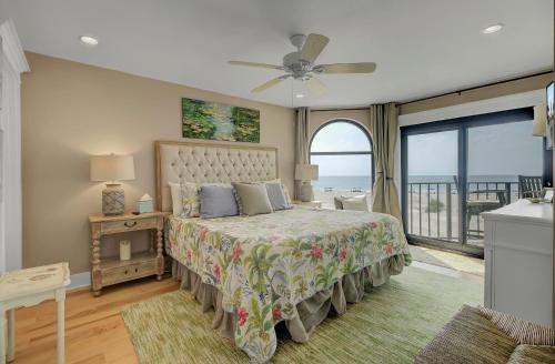 a bedroom with a bed with a view of the ocean at 211 Seascape by AvantStay Oceanfront View Pool in Isle of Palms