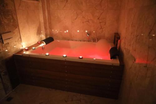 a red bath tub with lights in a bathroom at EDİ Group Turizm Sapanca Villas in Sapanca