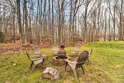 a group of chairs around a fire pit in a field at Near Big Boulder Mtn Cabin with Furnished Deck in Albrightsville