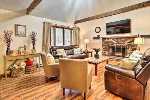 a living room with leather furniture and a fireplace at Near Big Boulder Mtn Cabin with Furnished Deck in Albrightsville
